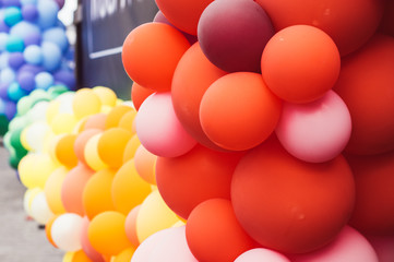 A lot of multicolored balloons, orange and red, pride festival