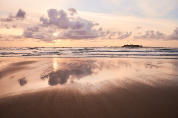 Beach of moledo at the end of the day, with a view to trega mountain on spanish side of the border. Low tide displaying the sandy beach on a cloudy day.