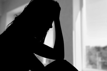 Young woman crying on background