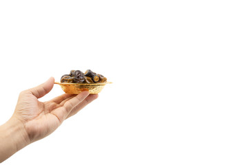 Hand holding dried dates fruits isolate on white. Selective focus
