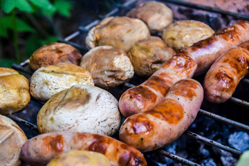 barbecue on the nature in summer mushrooms meat sausages kebab grilled over charcoal