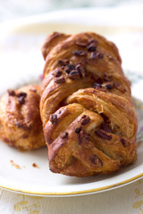  Freshly baked pastry with jam inside and macadamia nuts, on the plate, served for breakfast