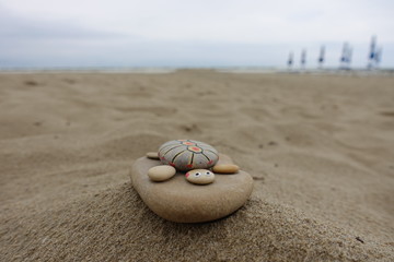Stone turtle on the beach, handmade work 