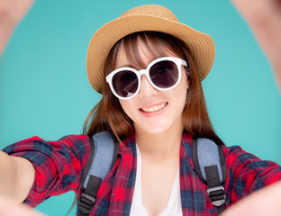 Beautiful young asian woman taking selfie with camera for relax in vacation isolated on blue background, asia girl wear clothes casual travel summer fashion excited, tourist and journey concept.