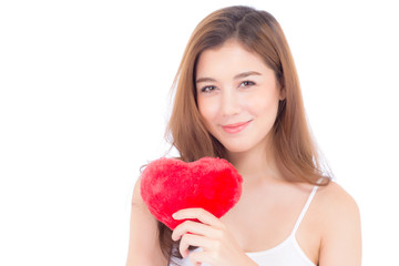 Portrait of beautiful asian young woman holding red heart shape pillow and smile isolated on white background, valentines day, holiday concept.