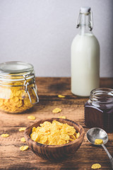 Breakfast with corn flakes, milk and jam