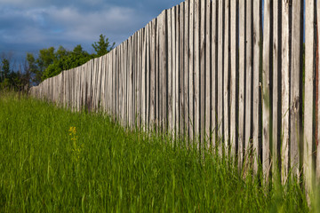 Wooden fence from the fence extending into the distance