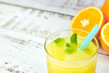 Fresh juice Orange juice in a glass with orange slices on light concrete. horizontal view. detox. close-up. copy space. citrus refreshing drink.