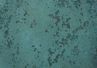 paint on the surface crumbling due to time and weather conditions