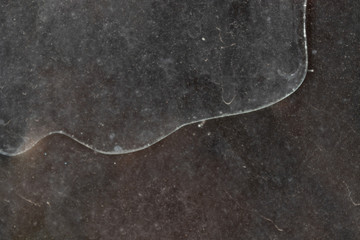 long curved crack on dirty and dusty glass in an abandoned building
