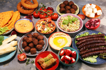 Middle eastern or arabic dishes and assorted meze, concrete rustic background. Falafel. Turkish Dessert Baklava with pistachio. Halal food. Lebanese cuisine