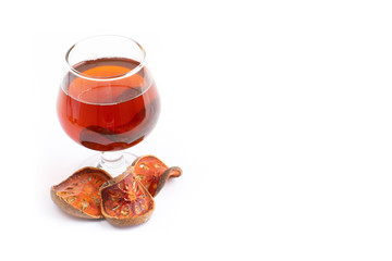 Bael fruit tea - A glass of Bael fruit tea and dried fruit Bale beverage On a white background