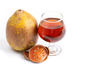 Bael fruit tea - A glass of Bael fruit tea and dried fruit Bale beverage On a white background
