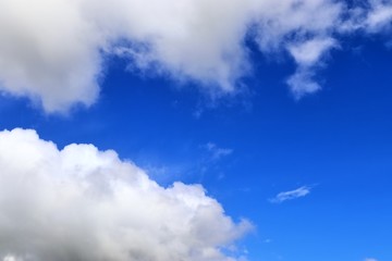 Beautiful white fluffy cloud formations on a blue sky taken in spring