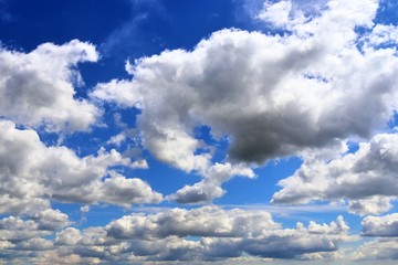 Beautiful white fluffy cloud formations on a blue sky taken in spring