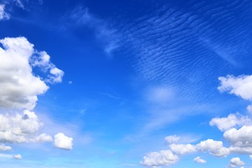 Beautiful white fluffy cloud formations on a blue sky taken in spring