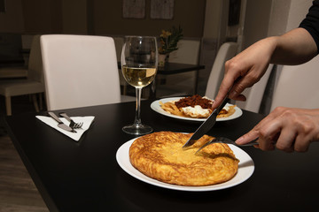 Delicious table set to eat, a delicious egg cake with a glass of wine and another dish more