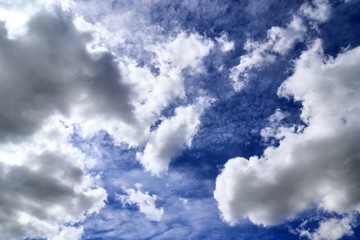 Beautiful white fluffy cloud formations on a blue sky taken in spring
