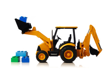 backhoe tractor with brick toys, white background
