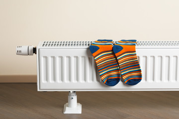 striped socks are being dry on the radiator