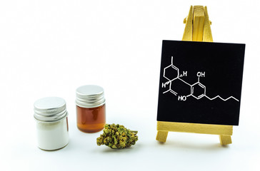 CBD Cannabidiol crystals isolate, cannabis resin and flower bud with blackboard with molecular...