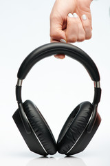 Hand hold black headphones