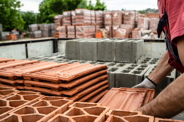 Clay tile and brick blocks concrete at the warehouse loaded in the back of the truck ready for the...