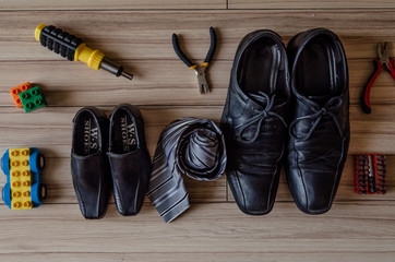 Happy fathers day, fathers shoes and baby boys shoes overhead, flat lay