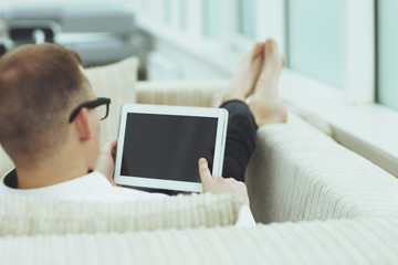 rear view.young man looking at digital tablet screen.