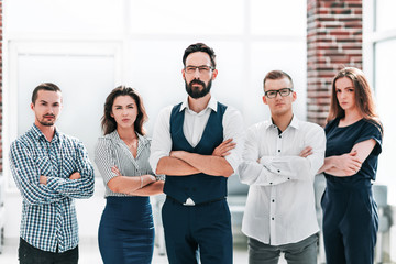 confident business team standing in a modern office