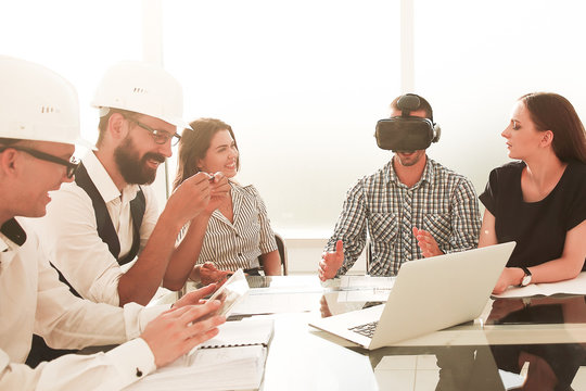 engineer in virtual reality glasses at a meeting with the business team
