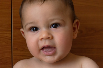 portrait face expresion of cute six months old baby boy