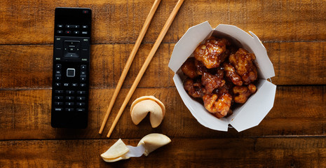 chinese take out with general tsos chicken on table top panorama