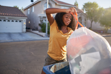 african american woman taking out the tash in las vegas neighborhood,