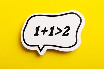 Synergy 1+1>2 Speech Bubble Isolated On Yellow Background