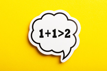 Synergy 1+1>2 Speech Bubble Isolated On Yellow Background