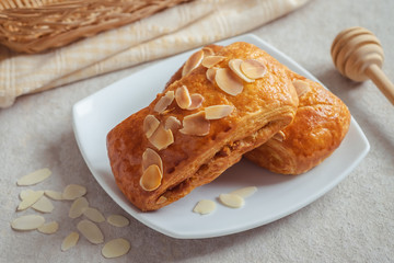 Almond danish pastry on white plate