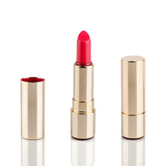 Obraz premium Red lipstick in golden tube on white background with mirror reflection on glass surface isolated close up, shiny gold lipstick package, open and closed lipsticks box, luxury cosmetic accessory set
