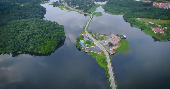 Aerial Shot of Lake Raban with sky reflection and road on the lake In Malaysia