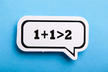 Synergy 1+1>2 Speech Bubble Isolated On Blue Background