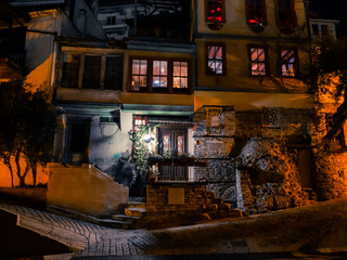 Naklejka na ściany i meble Old tavern at night in small Greek city