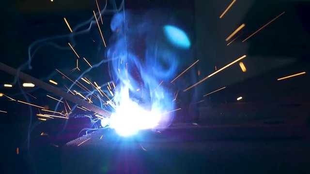 close up of stick welding steel in slow motion! fabrication of legs for a table!  6011 rod.