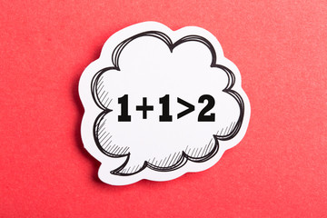 Synergy 1+1>2 Speech Bubble Isolated On Red Background