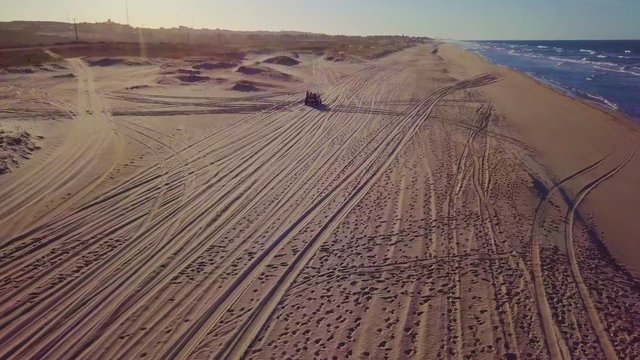 Aerial view of dune buggie passing by on the  Porto das Dunas Beach