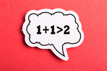 Synergy 1+1>2 Speech Bubble Isolated On Red Background