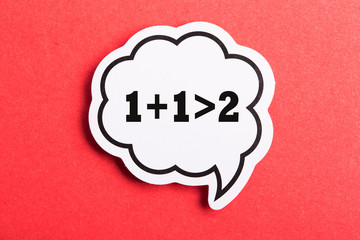 Synergy 1+1>2 Speech Bubble Isolated On Red Background