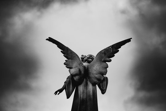 Guardian angel monument over a cloudy sky, memorial, eternal, remembrance