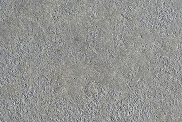 Fine exposed aggregate medium gray concrete surface.
