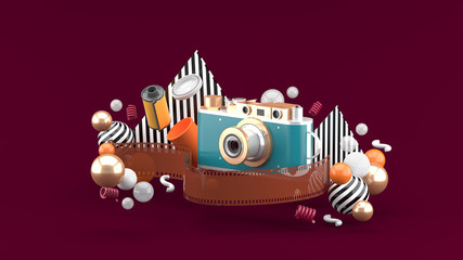 Film camera surrounded by film and colorful balls on a red backdground.-3d rendering.