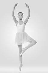 young girl ballerina posing on white background
